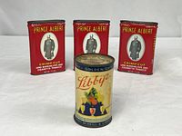Three Prince Albert tins and one Libby’s coin bank grouped