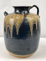 Front view showing full form, glaze pattern, unglazed foot