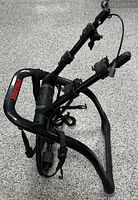 Full view of Yakima trunk-mounted rack showing frame, arms, straps