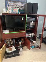 Cabinet showing Paradigm speakers, LG TV (not listed), interior shelves with Sony DAV-C700 and media