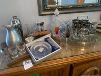 Overall view showing decanter, pitchers, martini glasses, coloured stemware, caddy with smoky glasses, boxed dish and tools