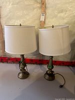 Full view of both brass lamps with shades