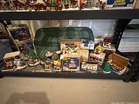 Bottom shelf view of boxed Country Villagers pieces and loose items