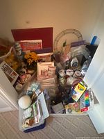 Overall view of bins filled with craft supplies including markers, pencils, ribbons, florals, mats, wreath frame