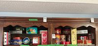 Overview of two shelving units showing numerous advertising and holiday tins