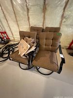 Front view showing two chairs with cushions and swivel bases