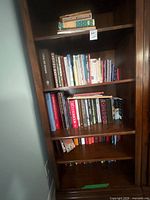 Full bookcase view showing all shelves of mixed books