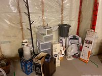 Overall view showing Shark mop box, storage drawers, coat rack, fan, trash bin and other items