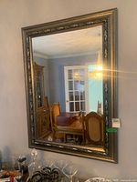 Full view of rectangular mirror hanging on wall showing overall size and frame style