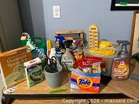 Overview of all garden chemicals, hose, gloves, thermometer, Tide pouch on tabletop
