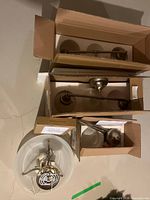 All boxed fixtures grouped: two vanity bars, ceiling light, brass-tone pendant