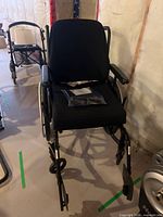 Front view of wheelchair showing cushion and accessories