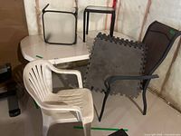 Lot overview showing table, chairs, side tables, foam mats