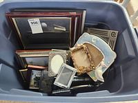 Bin containing numerous wood, metal, glass and ceramic frames of various sizes