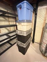Stack of four totes: blue, beige, two black with grey lids