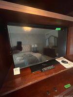 Front view of Samsung 31-inch LED TV inside cabinet