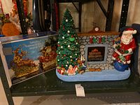 Box showing Santa sleigh set beside fireplace scene