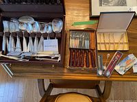 Overall lot showing flatware chest, gold spreaders, tortoiseshell knives and other utensils