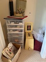 Overall lot showing sewing machine case, plastic drawer tower, pattern box and supplies