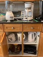 Overview of blender, coffee maker, toaster oven, hand mixer, two kettles, knife case