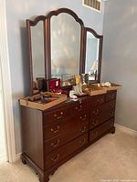 Full view dresser with tri-fold mirror and drawers visible