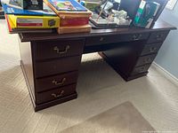 Front angled view showing overall desk layout, drawers, top surface