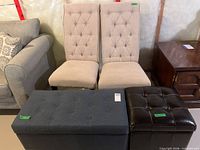 Front view of both beige chairs, blue storage bench and black ottoman