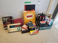 Group shot of all boxed games, card decks, poker chips