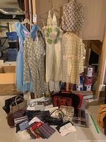 Full lot overview with dresses hanging and accessories on floor