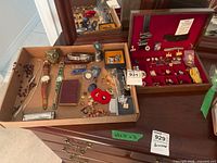 Overview of tray with assorted items and jewelry box on dresser