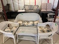 full patio set showing loveseat, two chairs, table, cushions