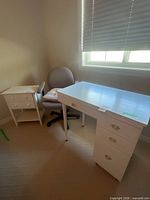 Desk, chair, and nightstand grouped together in room