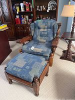 Front view of armchair and ottoman showing upholstery and wood frame