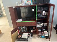 Front view showing overall cabinet, central TV compartment, glass door cabinet, lower doors