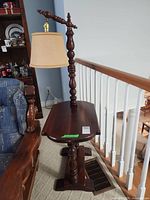 Full view of wooden floor lamp with side table and shade