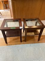 Both square wood side tables side by side showing glass tops and lower shelves