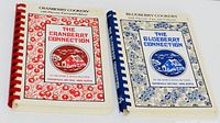 Front covers of both cookbooks showing titles, matching designs and spiral bindings