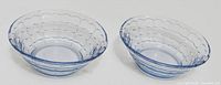 Two pale blue pressed glass dishes side by side