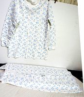 Long-sleeve top hanging, folded matching pieces below