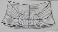 Top view of chrome wire fruit tray showing spiral base and rectangular shape