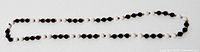 Full view of entire beaded necklace laid flat