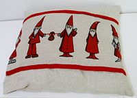 Front of pillow showing elf/gnome print and red stripes