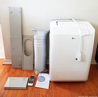 LG air conditioner with exhaust hose, window panels, remote, manual