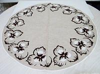 Front view showing entire tablecloth with brown and white floral border
