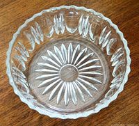 Top view showing starburst base and scalloped rim of clear cut glass bowl