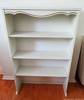 Front view of entire white three-shelf bookcase
