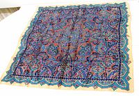 Full view of silk scarf laid flat showing entire pattern and border