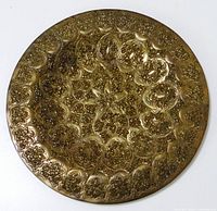 Front view of brass plate showing full etched design