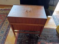 Closed teak bar cabinet on casters