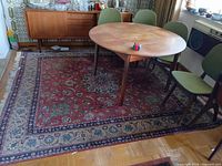 Full view of rug under dining table showing overall pattern, colors and size